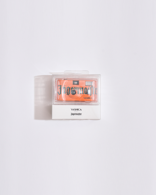 orange camera  in a clear plastic packaging on a white background