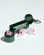 Earplugs in a green metal case with a white Jägermeister wordmork on it in a white background