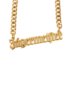 Gold necklace with 'Jägermeister' pendant.