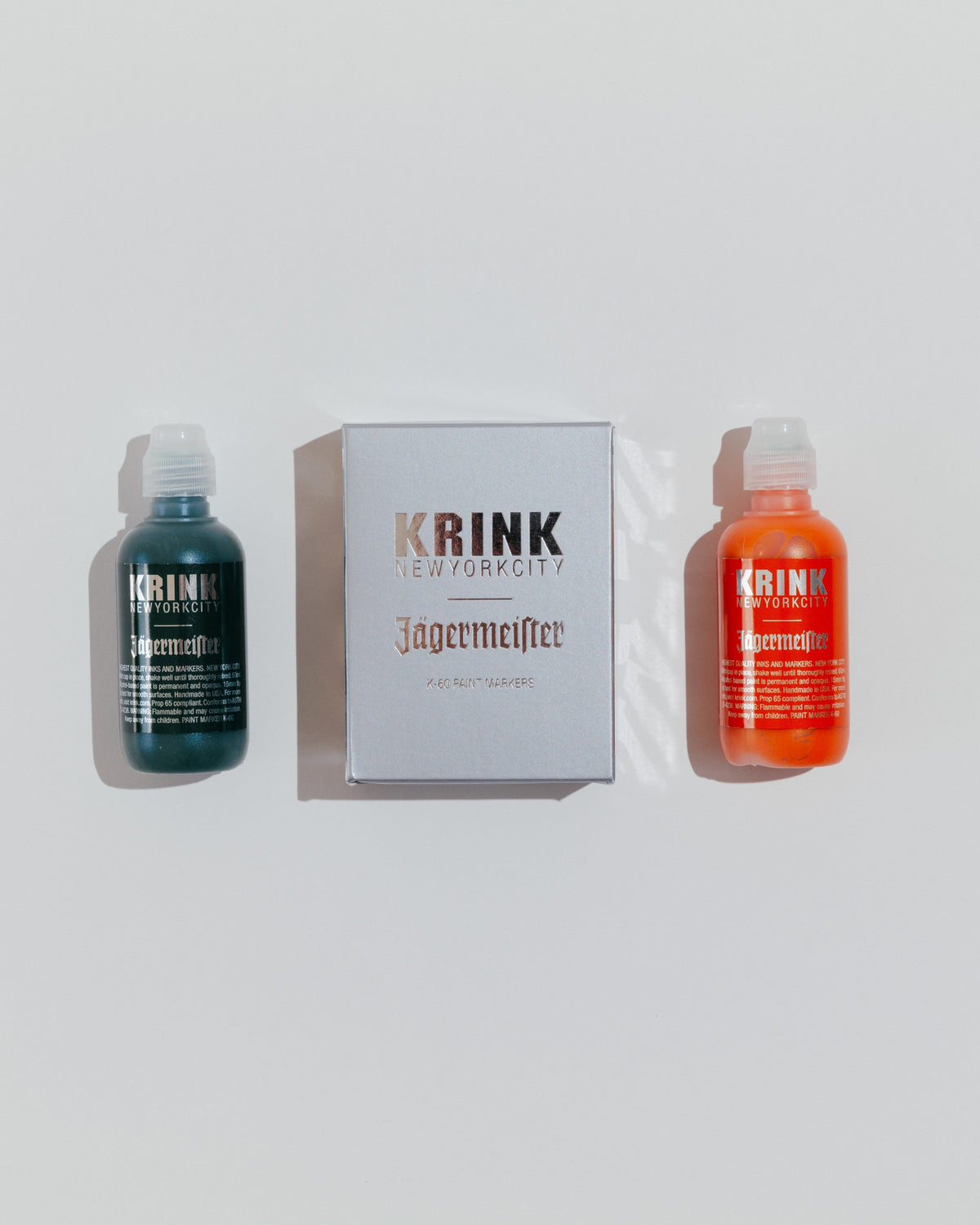 Two bottles of Krink paint markers and a Krink branded box 