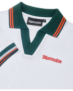 White polo dress close up with green collar and orange accents, featuring Jägermeister branding.