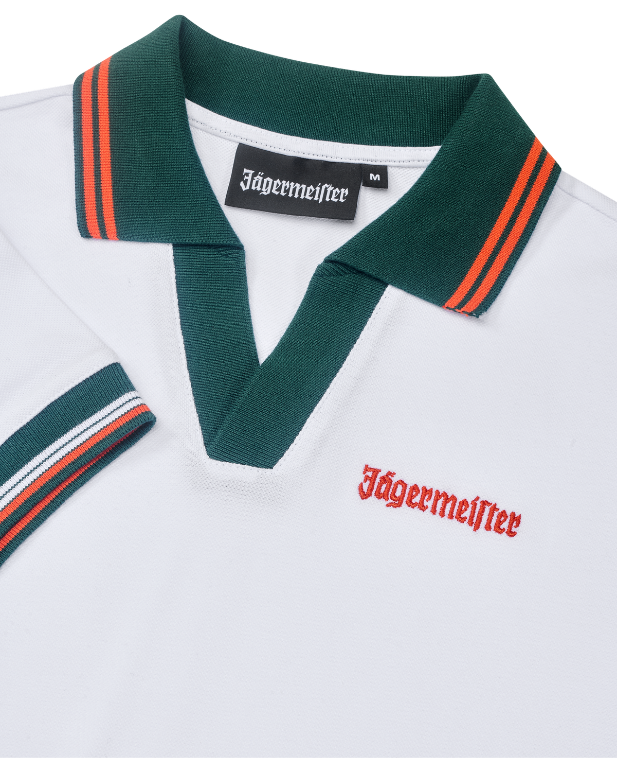 White polo dress close up with green collar and orange accents, featuring Jägermeister branding.