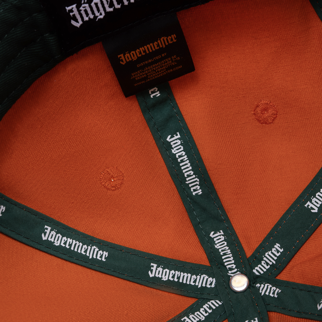 Orange Jägermeister Racing cap with Jägermeister branding on the strap and its label.