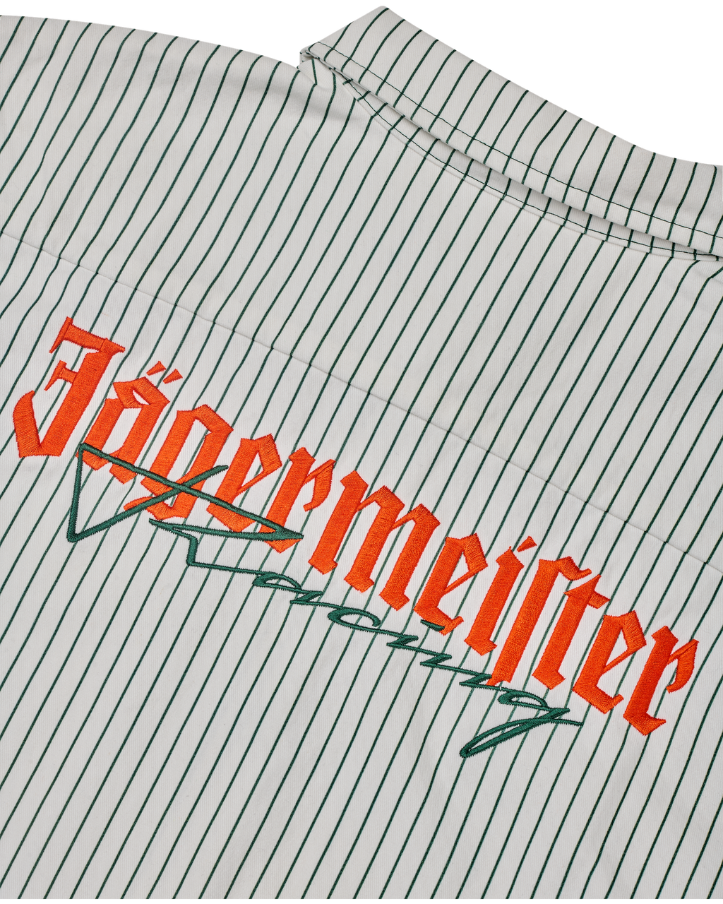 Close-up of a shirt with Jägermeister Racing logo on a white and dark green striped background