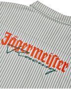 Close-up of a shirt with Jägermeister Racing logo on a white and dark green striped background