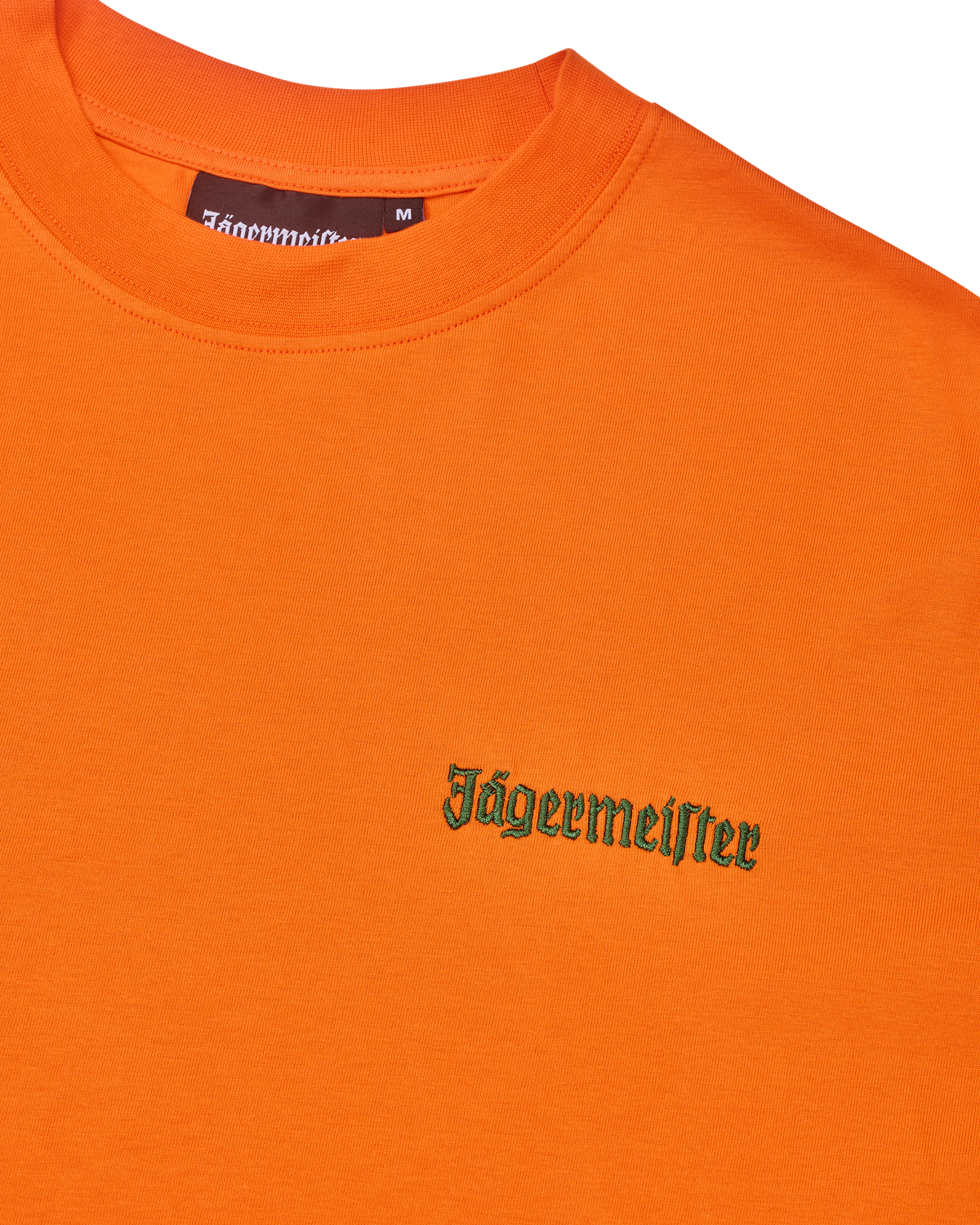Orange t-shirt with green Jägermeister logo on the chest.