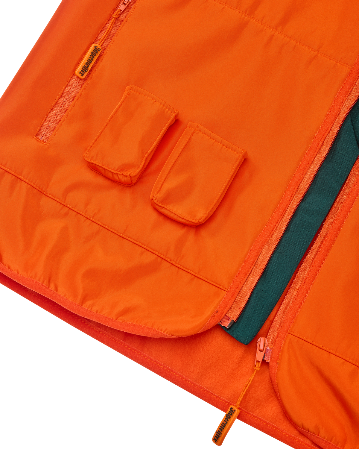 Close-up of an orange Jägermeister vest with two front pockets for Jägermeister Minis.